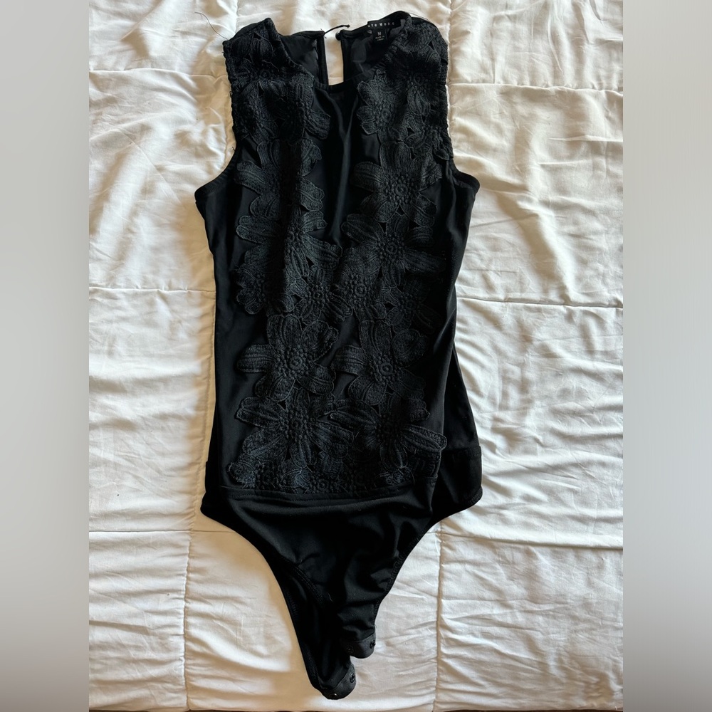 Lace bodysuit, sheer mesh back.